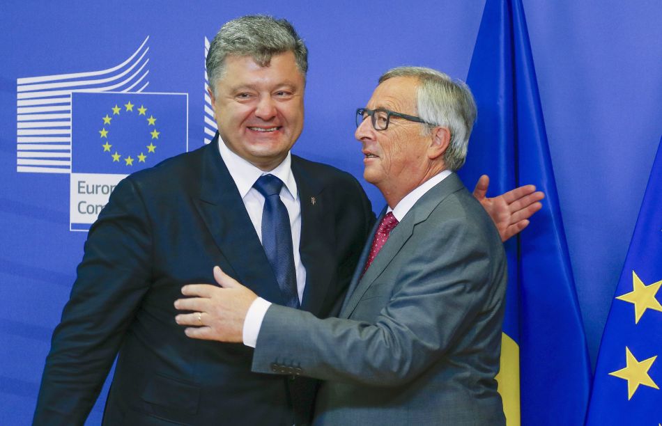 Poroshenko is welcomed by Juncker ahead of their meeting at the EU Commission headquarters in Brussels