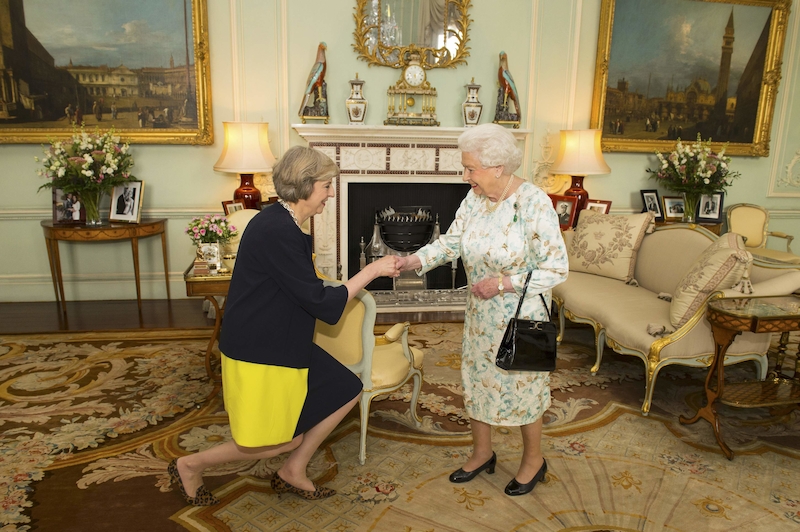 Britain's Queen Elizabeth welcomes Theresa May at the start of an audience in Buckingham Palace, where she invited her to become Prime Minister, in London