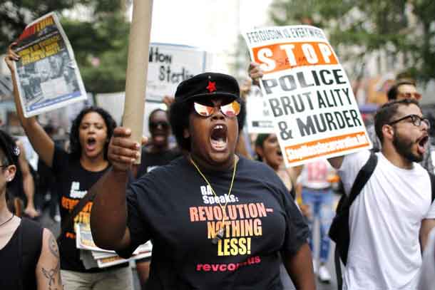 People take part in a protest for the killing of Alton Sterling and Philando Castilein during a march along Manhattan's streets in New York